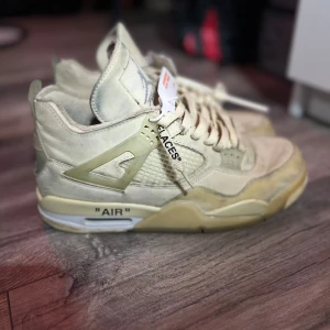 Beige Nike Air Jordans - Säljer ett par snygga beige Nike Air Jordans i bra skick. De har en cool design med texten 'AIR' på sulan och kommer med originalsnören. Perfekta för både vardag och fest! Skorna har en unik stil som verkligen sticker ut.