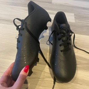 Svarta fotbollsskor från Adidas - Säljer ett par svarta fotbollsskor från Adidas. Endast ”test” använda då jag kommit fram till att de är något stora! 