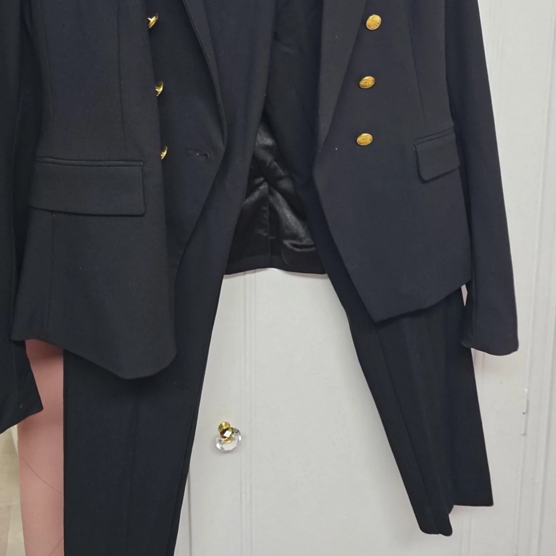 Svart kavaj med guldknappar och byxa