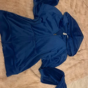 Blå hoodie från Divided - Säljer en mjuk och bekväm blå hoodie från H&M Divided. Den har en dragkedja framtill och en stor huva. Perfekt för en avslappnad stil. Fickor på sidorna för extra funktionalitet. Passar perfekt för kyliga dagar.