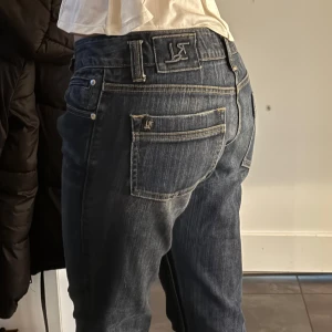 Blå jeans med bootcut - Säljer ett par snygga blå jeans med bootcut. De har en klassisk femficksdesign och är i bra skick. Perfekta för både vardag och fest!
