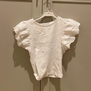 Vit topp med spetsärmar - Säljer en söt vit topp med volangärmar. Är i från Zara som inte säljs längre. Är sååå fin men är tyvärr för liten för mig. 🤍