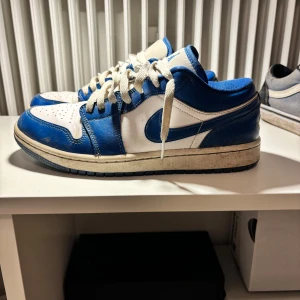 Nike Air Jordans i blått och vitt - Snygga Nike Air Jordans i blått och vitt med klassisk snörning. Perfekta för dig som älskar en sportig stil. Skorna har en ikonisk design med Air Jordan-loggan på hälen.