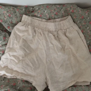Beige linneshorts från Chiquelle - Säljer ett par beige shorts från Chiquelle i linneblandning. De har en elastisk midja för en skön passform. Perfekta för varma sommardagar! Storlek XS men passar S/M också. Säljer pga stor i storleken och att de inte kommer till användning💞🌸🫶🏼☺️