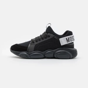 Svarta sneakers från Moschino storlek 42 - Stilrena svarta sneakers från Moschino med en chunky sula och snörning. Skorna har en vit rem med Moschino-logga baktill och detaljer i syntetmaterial. Perfekta för en trendig look.Säljer mina moschino skor helt nya med kartong och påse mycket fina skor tyvärr har jag ingen behov av skorna och är för små för mig helt nya aldrig använda endast testade köptes för 5000kr 