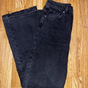 Svarta jeans med bred passform - Snygga svarta jeans med en bred passform och normal midja. Perfekta för en avslappnad stil.