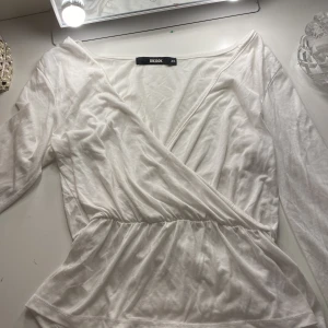 Vit omlottopp från Bik Bok - Säljer en  vit omlottopp från Bik Bok i storlek XS, då jag har många liknande. Knappt använd i mycket bra skick💕
