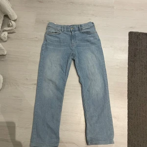 Ljusblå jeans från GANT - Säljer ett par ljusblå jeans från GANT. De har en klassisk femficksdesign och en snygg läderdetalj med logotyp på baksidan. Perfekta för en avslappnad stil. Har även sytt upp byxorna ca 2cm på insidan som inte syns eftersom dom var för stora när jag fick dom. 