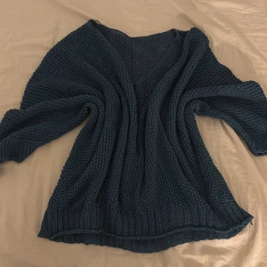 Mörkt blå stickad genomskinlig tröja - Detta är en mörkblå stickad genomskinlig tröja .