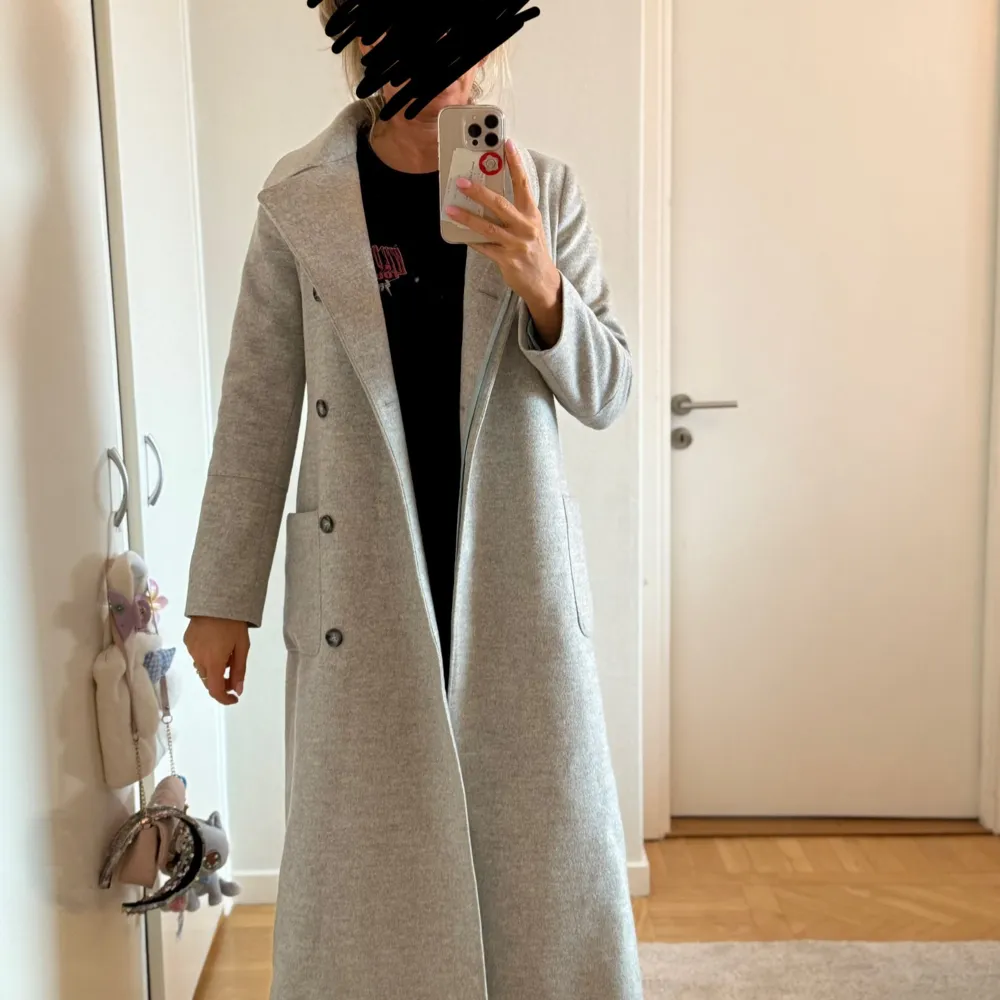 Säljer en elegant grå kappa från Morris Lady i storlek 36. Den är tillverkad av 100% ull och har en stilren design med knappar framtill och en slits bak. Perfekt för höst och vinter, och ger en klassisk look till vilken outfit som helst.. Takit.