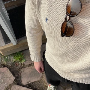 Ralph lauren tröja - Säljer supermysig stickad Ralph Lauren tröja i storlek S. Den är bone/creme färg. Perfekt skick. Mått finns på 3e bild😊