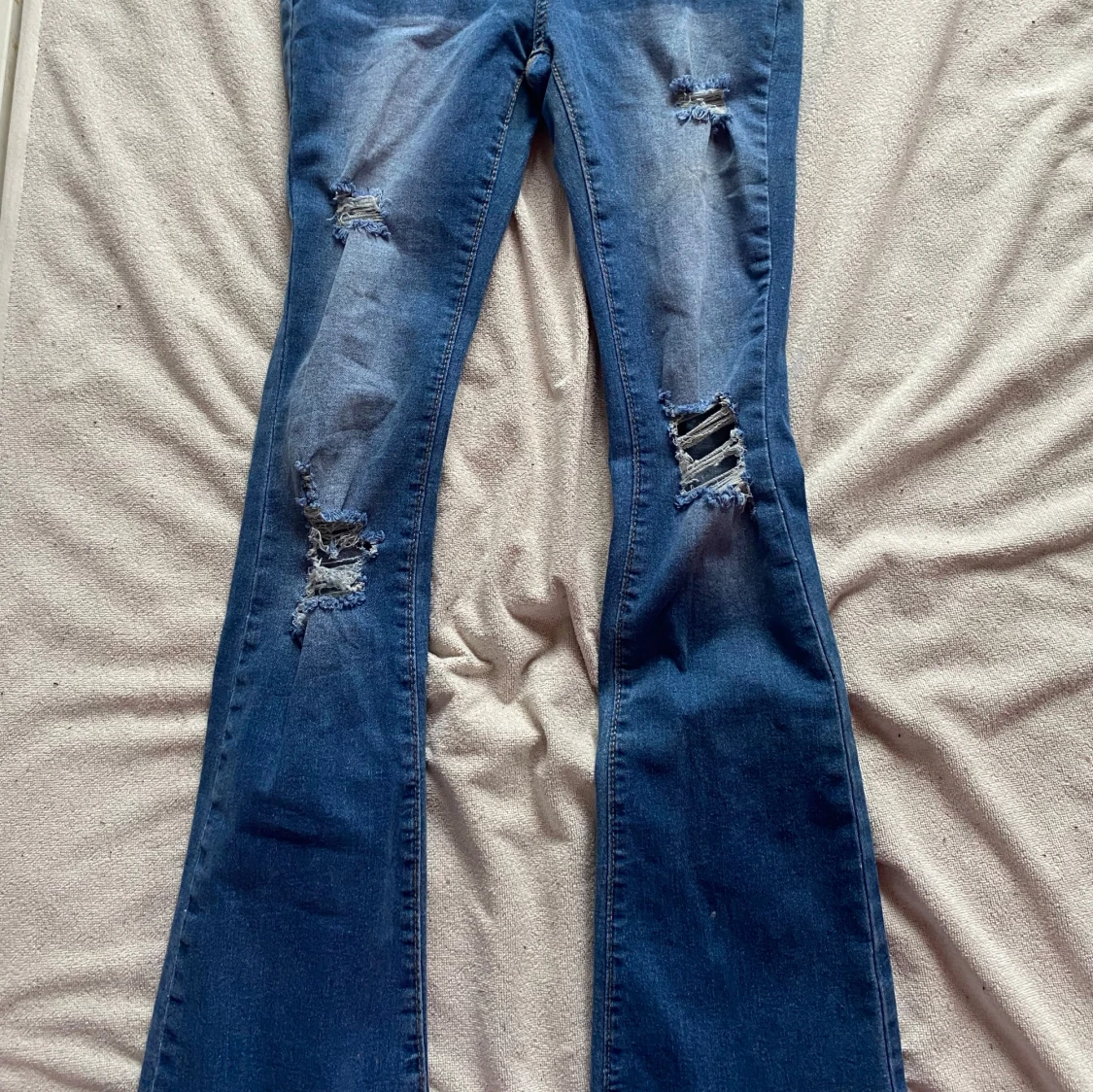 Flared mid waist ripped jeans