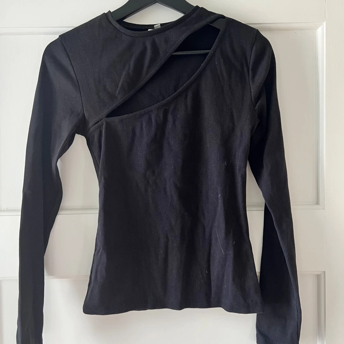 Svart ribbad topp med asymmetrisk design