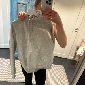 Grå hoodie - Säljer en stilren grå hoodie. Tröjan har en klassisk design med långa ärmar och en bekväm passform. Perfekt för en avslappnad look. Den är från Bikbok i storlek s-m!🥰