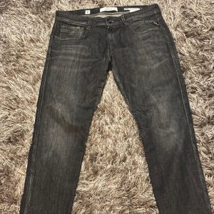 Svarta/gråa jeans från Replay - Snygga svarta jeans från Replay, modell Anbass. De är slim fit och i storlek 33/32. Har knappt hunnit använda dessa från när ja köpte dom och vill helt enkelt bara bli av med dom. 
