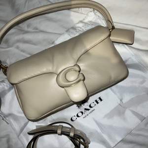 Säljer helg ny Coach Pillow tabby shoulder bag 26 i färgen Ivory. Väldigt fin väska men har ej kommit till användning. Nypris 6 245kr, Mitt pris 3200 kr är fast vid priset, kvitto finns :)