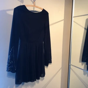 Klänning från Nelly i strl S - Svart klänning från Nelly i storlek s. Dragkedja i bak och paljetter på ärmarna. Jättefin, endast använd ett fåtal gånger. 