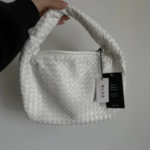 Nakd väska - Vit vävd nakd väska, helt oanvänd. Slutsåld hos nakd.