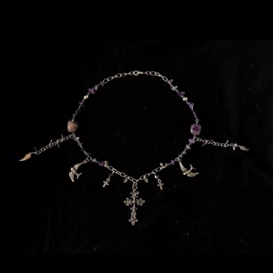 Handgjort halsband  - Ett halsband med äkta ametist, kors och fåglar. Super fint och fyllt med positiv energi! Obs håll borta från direkt solljus då ametist förlorar sin fina färg!