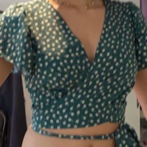 grön tröja  - En jättefin tröja i storlek S. Den passar nästan alla då den knyts runt midjan. Den har en V neck och man knuter snöret runt midjan och sedan i en rosett. Jättefin och passar extra bra då sommaren närmar sig. Tröjan är i ett jättefint skick då jag använt den få tal gånger och den bara lugit i min garderob. Jag säljer den pga att den inte används. Skriv till mig privat för mer info och bilder om du är intresserad. Köparen står för frakten 