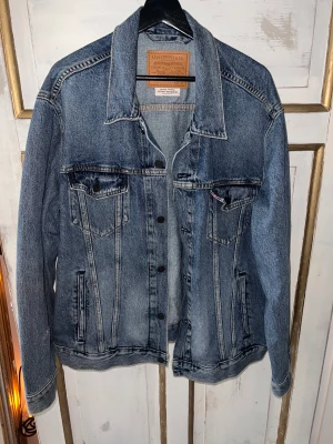 Levis Jeans Jacka Premium Blå - 7/10 skick, Lite slitage på vänstra armen (se bild 3). Annars kanppt använd.  XL Kan mötas upp i Stockholm 