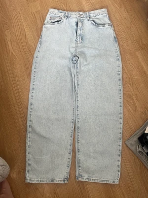 Jeans Ginatricot  - Ljusblå jeans i snygg färg från Ginatricot. Skicket är som nytt. En vidare modell på benen med hög midja. Strl 40. 