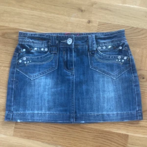 Jeans kjol - Jättefin lågmidjad jeanskjol, någon enstaka nit som tappats på bakfickan. Ska vara i storlek 34 men skulle säga att den är väldigt liten. Skulle nog bäst passa för 30-32?