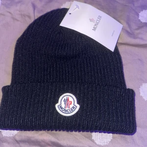 Moncler Mössa - En moncler mössa som tyvärr inte passar mig alls. Därför vill jag sälja bort den för bra pris. Ord. Pris 1100kr