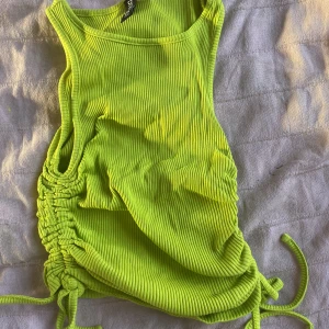 Neon gul/grön topp - Neon topp med snören i sidannför att kunna justera. Väldigt stretchig. Bra skick, storlek xs. 