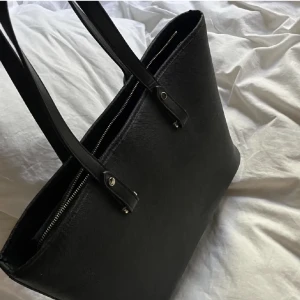 Hm väska  - Säljer en väska från hm, den är rymlig och man får plats med mycket! Väskan är i jätte bra skick då jag inte använt den alls knappt! Bilderna är lånade så kontakta för egna bilder