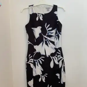 Nästintill oanvänd blommönstrad klänning från H&M i storlek S. Klänningen har en dragkedja som går över halva ryggen, vilket gör klänningen lätta att ta på och av. Basen på klänningen är svart och blommönstret är vitt och blått. Endast använd 1 gång.