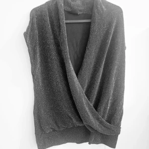 Svart glittrig top från Kappahl - Svart topp glittrig (silvrig) se bilderna. Från Kappahl i storlek M. Använd någr gånger på krogvistelser