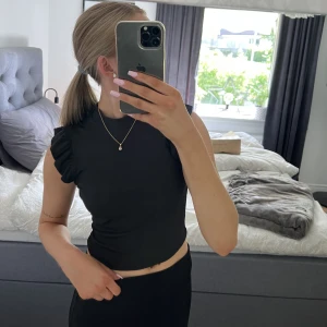 Svart volangtopp  - Svart topp med volanger på armarna💕