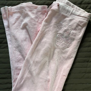 Juicy Couture Mjukisbyxor - Storlek M men är väldigt liten i storleken. Passar mig som är XS, dock lite korta i benen (jag är 170).   Inga fickor på baksidan men tryck på framsidan (se bild 2). Ena snöret har tappat spännet (se bild 3). 