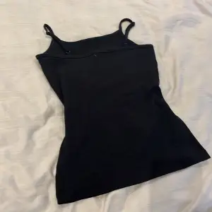 En svart basic linne som man kan ändra till vilken storlek man vill vid axeln, tvättas innan skick