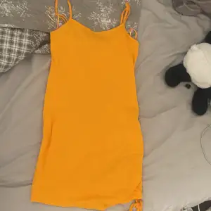 Orange klänning med en dragning vid sidan, köpt på defacto i turkiet och har använt endast en gång. Är en L men passar bra på M