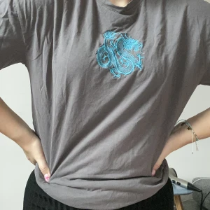 T-shirt med broderade drake - Fin tshirt med broderad drake. Storlek M!