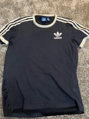 Adidaströja  - En marinblå adidaströja med satin material på baksidan. Säljer då den aldrig kommer till användning längre, storlek M. Köparen står för frakten 
