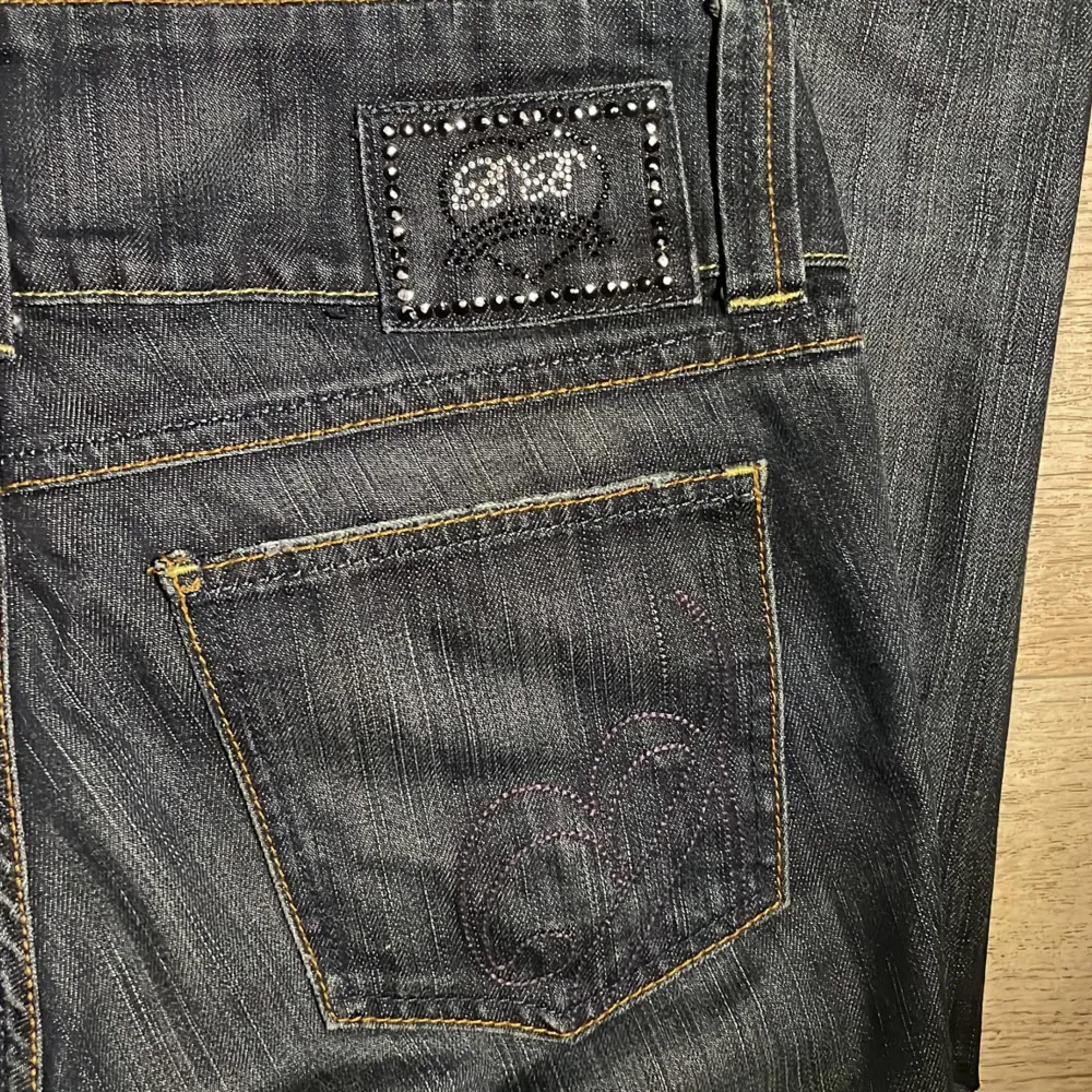 Vintage jeans från bikbok som inte säljs lägre med jätte snygga detaljer på baksidan💕 Innebenslängd: ca 72 cm, midja tvärs över: 41cm. Färgen på stenarna har gått bort lite men det syns inte💞 Skriv för fler bilder eller frågor💓. Jeans & Byxor.