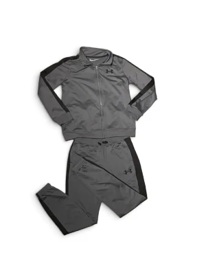 Grå träningsdress från Under Armour - Säljer en grå träningsdress från Under Armour med svarta detaljer längs ärmar och ben. Setet består av zip-jacka med hög krage och matchande byxor, båda i mjukt och stretchigt funktionsmaterial. Perfekt för gymmet eller chill dagar.