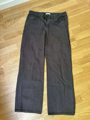 Bruna raka jeans med vida ben - Säljer ett par bruna jeans med raka, vida ben och klassisk femficksdesign. Jeansen har normal midja och är tillverkade i ett mjukt denimtyg. Perfekta för en avslappnad och trendig look. Perfect jeans från Gina tricot 