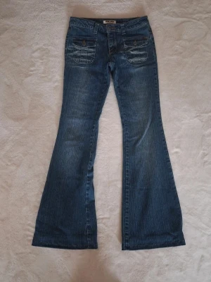 Jeans - Ett par lågmidjade utsvängda jeans från stone eagle. Jag har sytt upp dem längst ner!