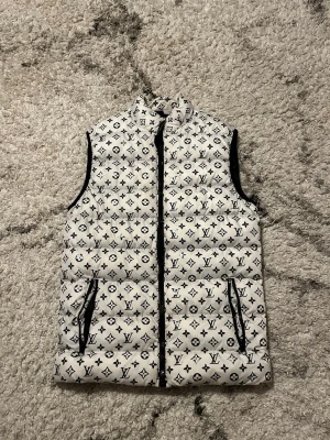 Luis Vuitton Väst (Semi Puffer) - Super fin LV Väst, knappt använd, sitter extremt bra på normal kroppsvikt, inga skador vad jag vet, helt ren och fin!        Tar bud om priset ej passar! Sålänge det sker snabbt så är den din!