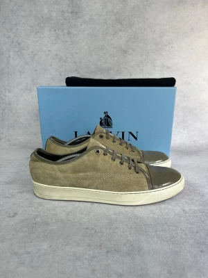 Lanvin DBB1 cap toe sneaker - – Condition: 8/10  - Size: 45/UK11  – What is included: Only the sneakers  – Retail price: 5000 + SEK  Please note that Lanvins fit big and our recommendation is to go one size down