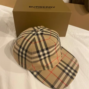 Burberry Keps - En fin Burberry keps perfekt inför sommaren. Priset är ej hugget i sten. Box och bag medföljer 