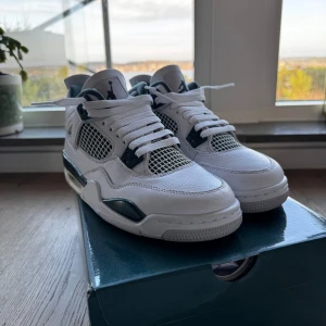 Nike Air Jordan 4 Retro - Snygga Nike Air Jordan 4 Retro sneakers i vitt med detaljer i oxidgrön. Skorna har en klassisk design med snörning och den ikoniska Jumpman-loggan på hälen. Perfekta för dig som vill ha en stilren look med en touch av färg. Priset kan sänkas och skriv om ni är intresserade. Skorna finns i Tyresö