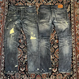 Vintage tvättade jeans - Helt stört snygga jeans, märket är jack n Jones men har åldrats med riktigt snyggt därav priset. Jeans med en sån här wash är inte alltid man hittar.    Mått: Midja: 43,5cm Längd: 104cm  Benöppning: 17 cm