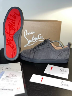 Christian Louboutin Skor Gråa - Nu säljer jag mina gråa Christian Louboutin-sneakers som tyvärr blivit alldeles för lite använda. De förtjänar en ny ägare som faktiskt kommer njuta av dem!  ✔️ Kvitto och alla papper ingår ✔️ I superfint skick, knappt använda ✔️ Kommer med originalkartong och allt som följde med ✔️ Creasing skydd kommer med De är riktigt snygga med den klassiska röda sulan och mjuk grå mocka - väldigt stilrena och lätta att matcha. Pris går absolut att förhandla, så känn dig inte blyg att skriva!