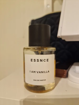 ESSNCE I Am Vanilla parfym - Modern Eau de Parfum med enkel design och tydlig vaniljprofil. Perfekt för dig som vill sticka ut med en unik doft. Flaskan är stilren och passar bra i väskan eller på hyllan. Namnet och varumärket syns tydligt på etiketten. Använd men finns mycket kvar i flaska