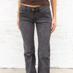 Bootcut jeans från brandy melville  - Snygga grå jeans med låg midja och bootcut passform. Jeansen har klassisk femficksdesign, normal midja och raka ben som blir vidare nertill. Använda en gång!! 